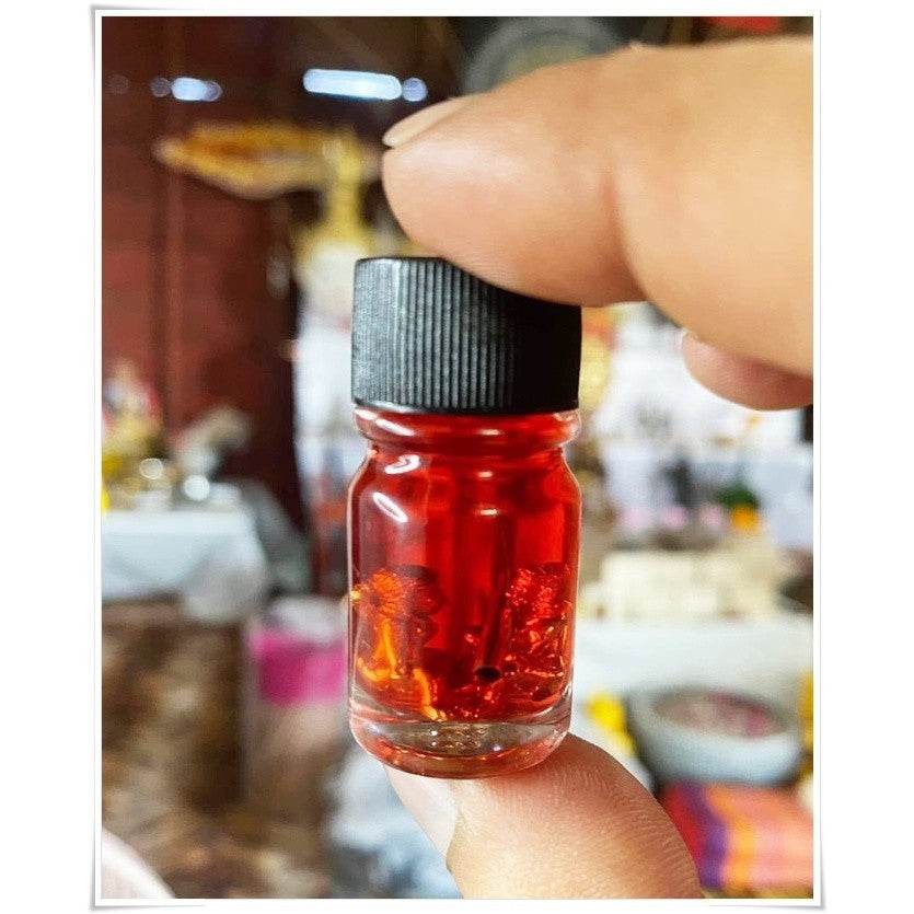 Small bottle of Thai Blessing spiritual oil for rekindling love, featuring a vibrant red liquid
