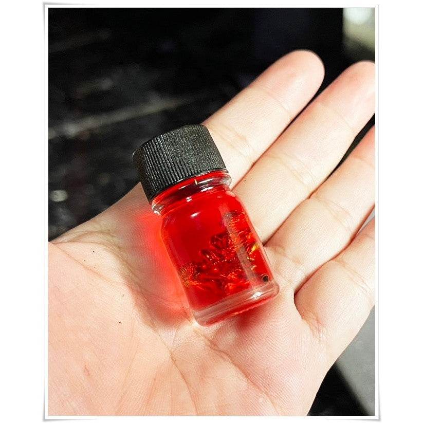 Thai Blessing spiritual oil for rekindling love in a small glass bottle, perfect for enhancing relationships