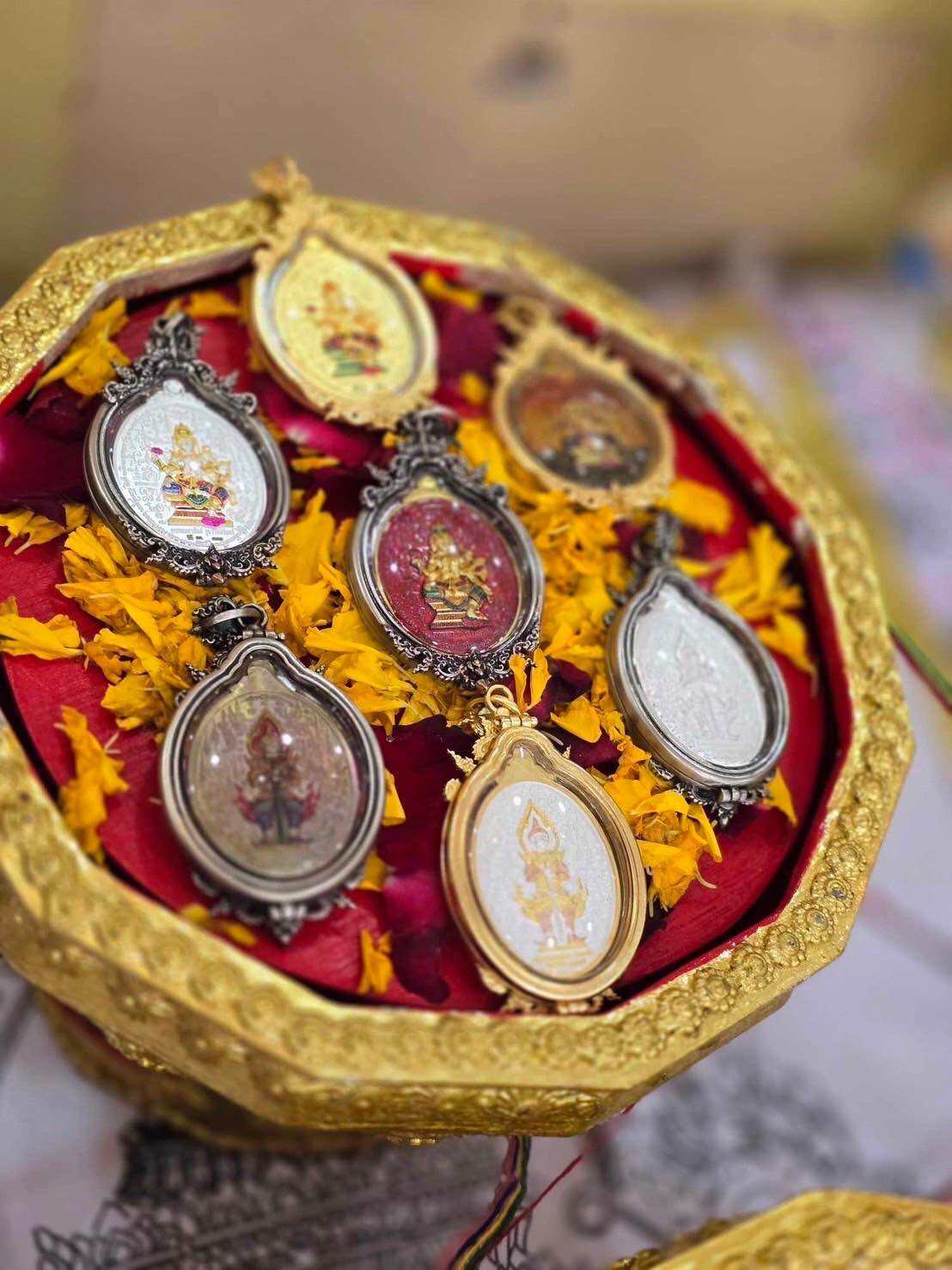 Supreme Brahma amulet by Phra Ajarn Weeraphon displayed on a decorative tray with marigold petals