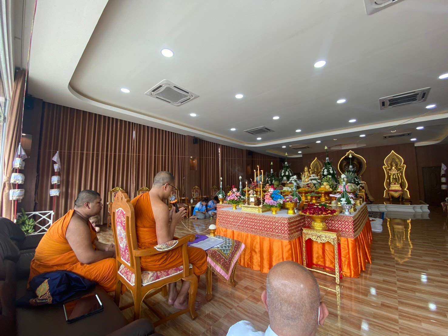 Ceremony featuring monks blessing the Supreme Brahma amulet by Phra Ajarn Weeraphon in a serene hall