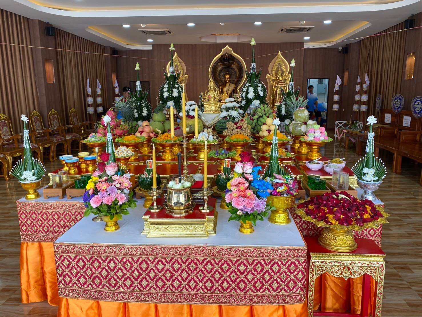 Ceremonial altar setup featuring vibrant offerings and the Supreme Brahma amulet by Phra Ajarn Weeraphon