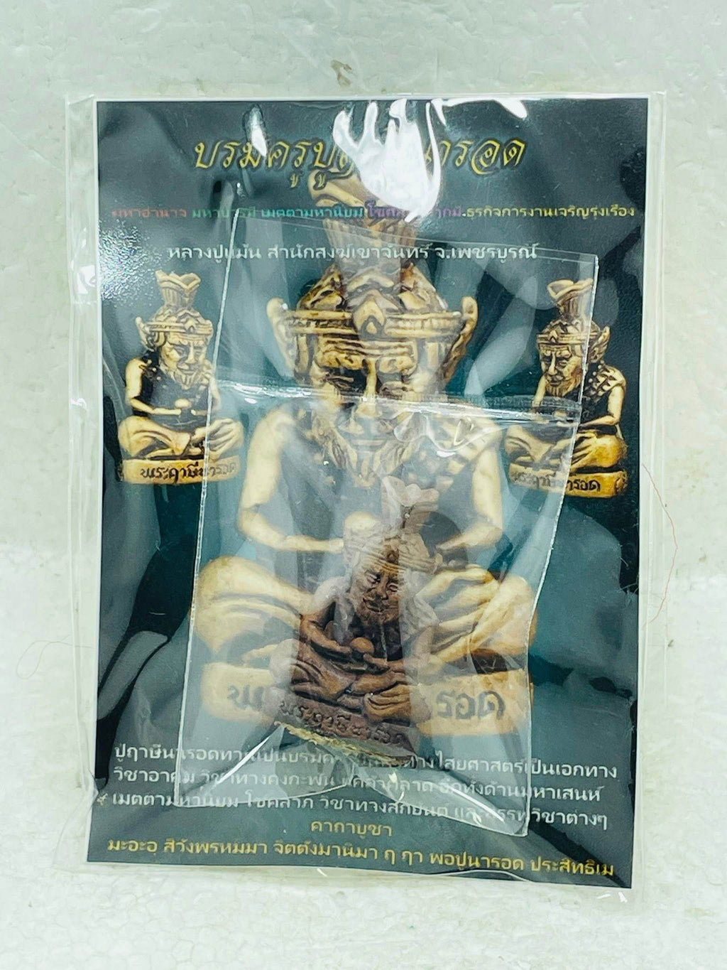 Supreme Ruesi Narot amulet enclosed in protective packaging with detailed instructions for use