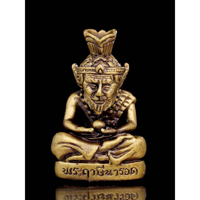 Supreme Ruesi Narot amulet in gold color, depicting a meditative figure holding a sphere, symbolizing spiritual protection