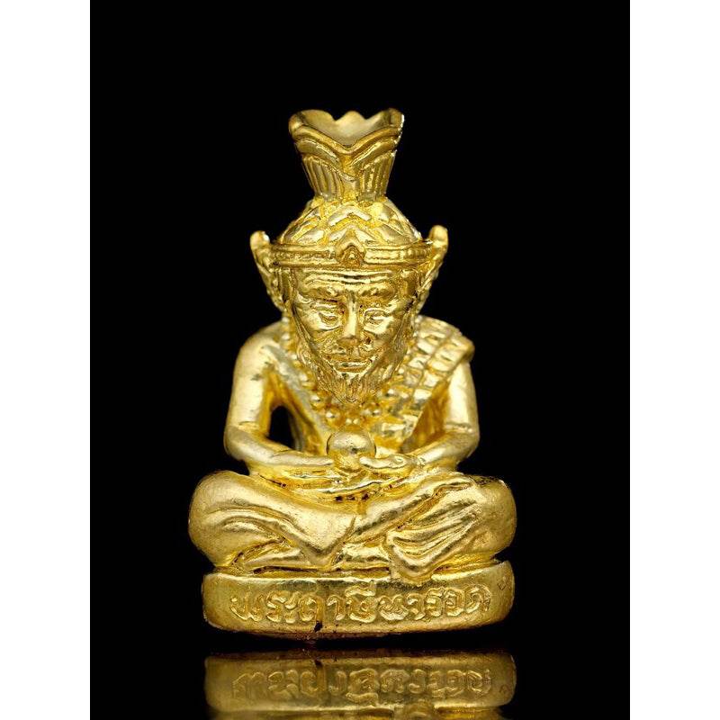 Supreme Ruesi Narot amulet in gold tone, depicting a seated figure with intricate details for spiritual blessings