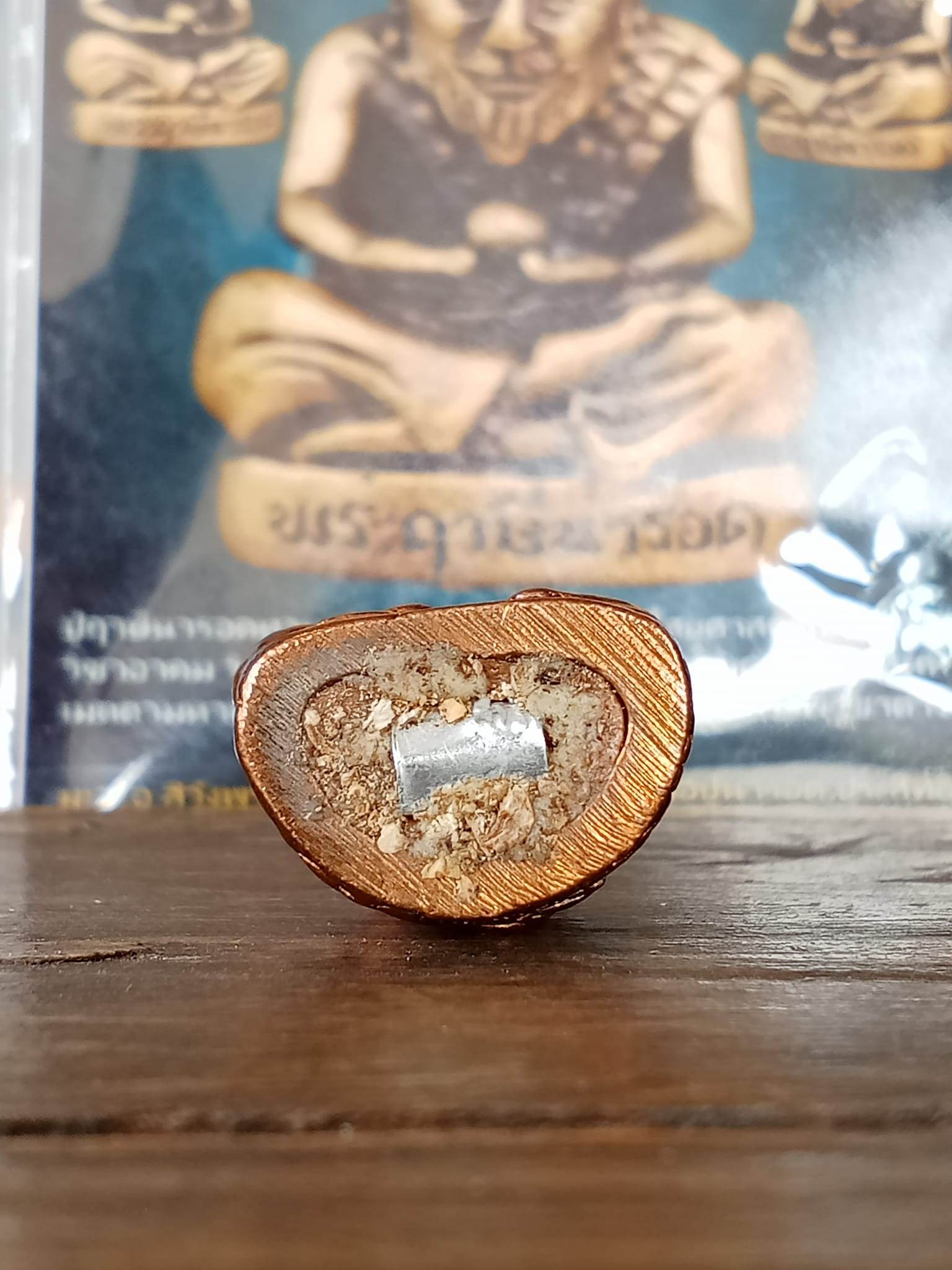 Supreme Ruesi Narot amulet, crafted from natural wood with a protective silver core for spiritual blessings