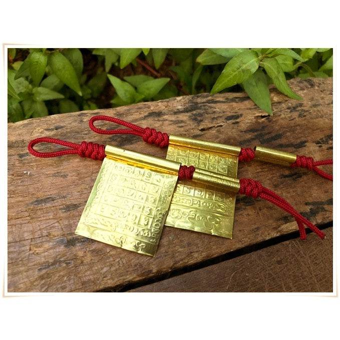 Takrud Maha Phitsawat love charm from Thai Blessing Co, crafted in gold with intricate designs for enhancing love and luck.