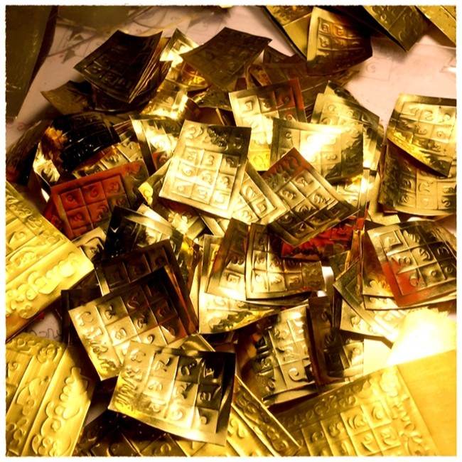 Golden Takrud Maha Phitsawat love charm pieces for Feng Shui and religious practices.