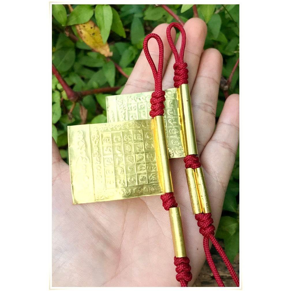 Takrud Maha Phitsawat love charm in gold color, featuring traditional inscriptions for enhanced luck and love.