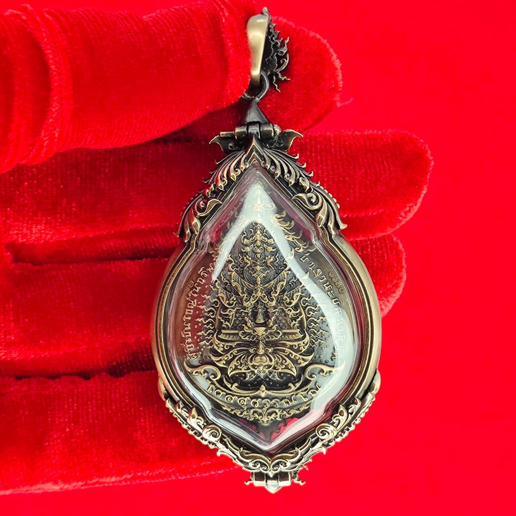 Tao Wessuwan amulet for protection displayed on a red background showcasing intricate detailing