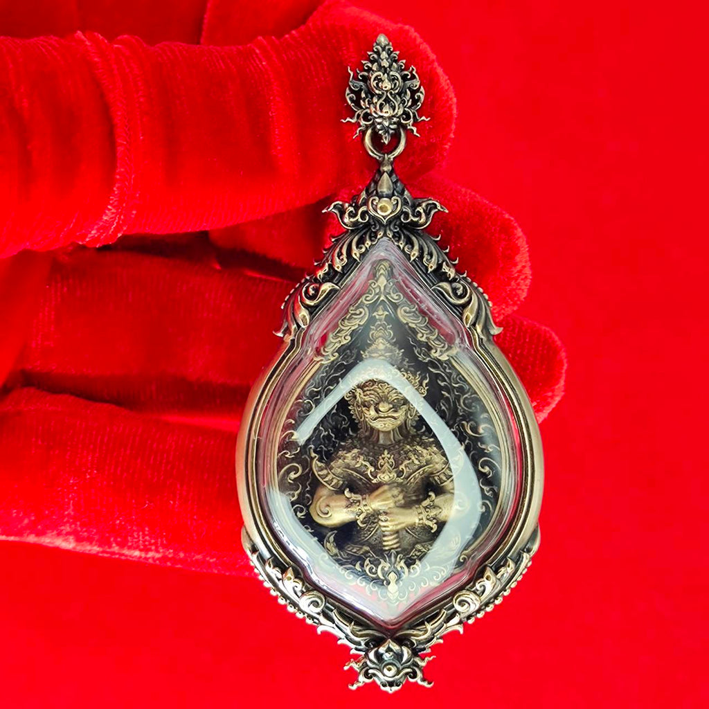 Close-up of a detailed Tao Wessuwan amulet for protection with ornate design and protective symbols