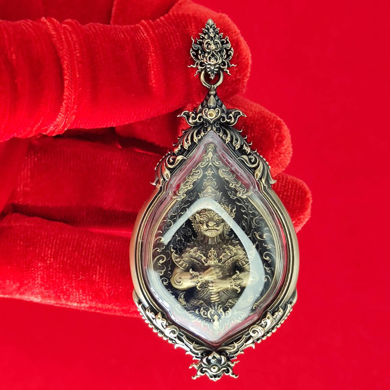 Close-up of a detailed Tao Wessuwan amulet for protection with ornate design and protective symbols
