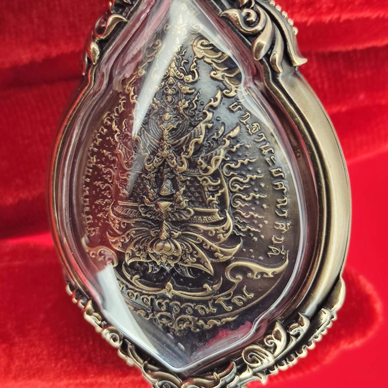 Tao Wessuwan amulet for protection encased in decorative frame with intricate details
