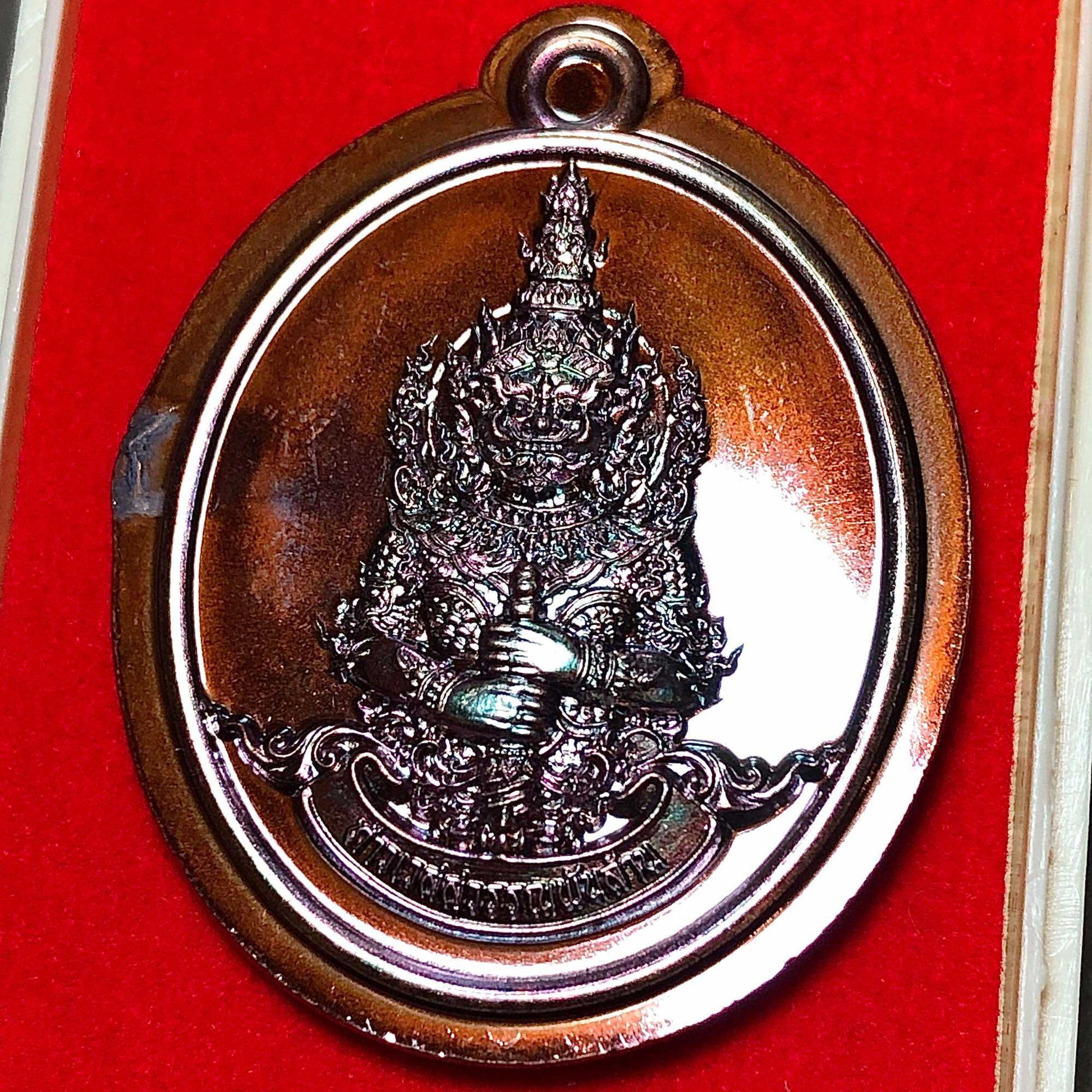 Tao Wessuwan amulet for wealth in copper finish, displayed on red velvet background, designed for prosperity.