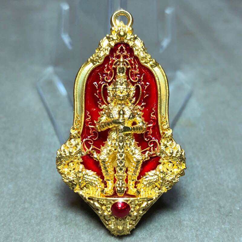 Tao Wessuwan amulet for wealth in gold and red design, featuring intricate detailing and a gemstone