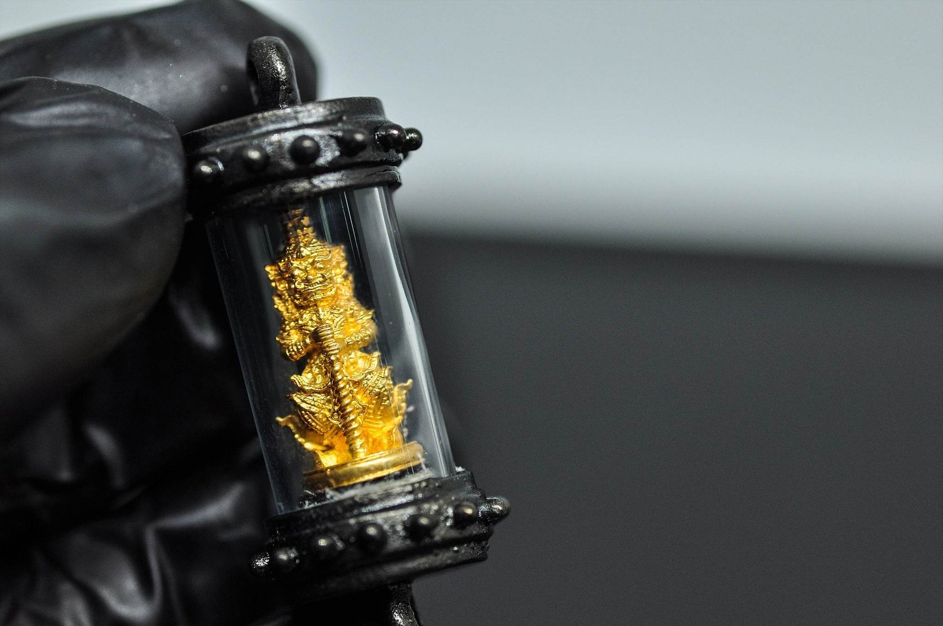 Tao Wessuwan amulet Thailand in a protective casing, perfect for wellbeing and spiritual blessings