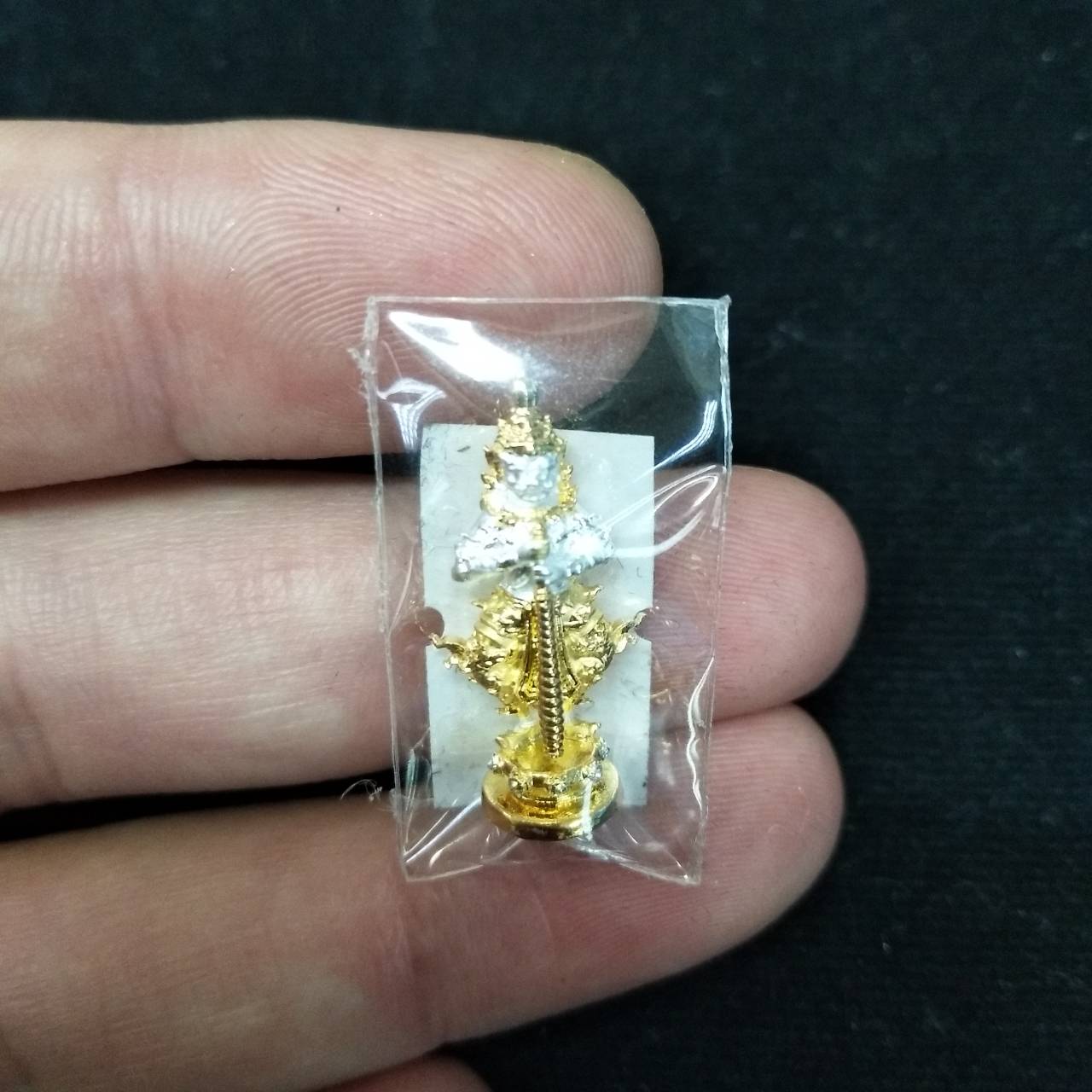 Taow Wessuwan amulet for wealth displayed in protective packaging for good fortune collectors