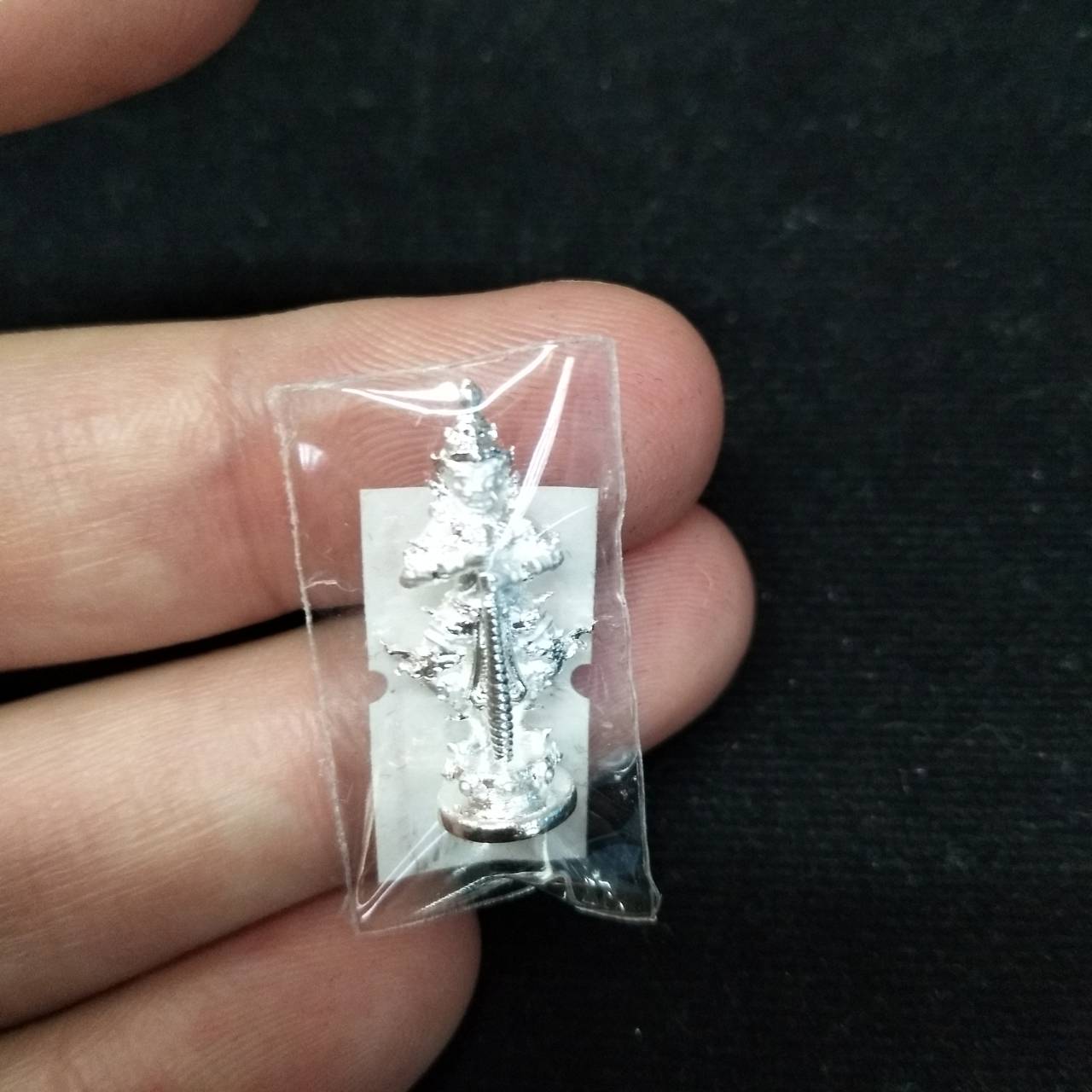 Taow Wessuwan amulet for wealth in silver packaging, perfect for home decoration and spiritual collection