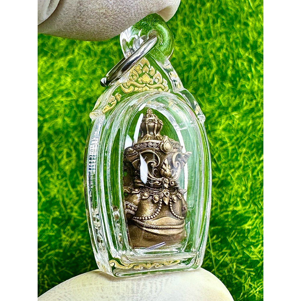 Taowessuwan amulet blessed by monk in clear protective case with intricate gold details