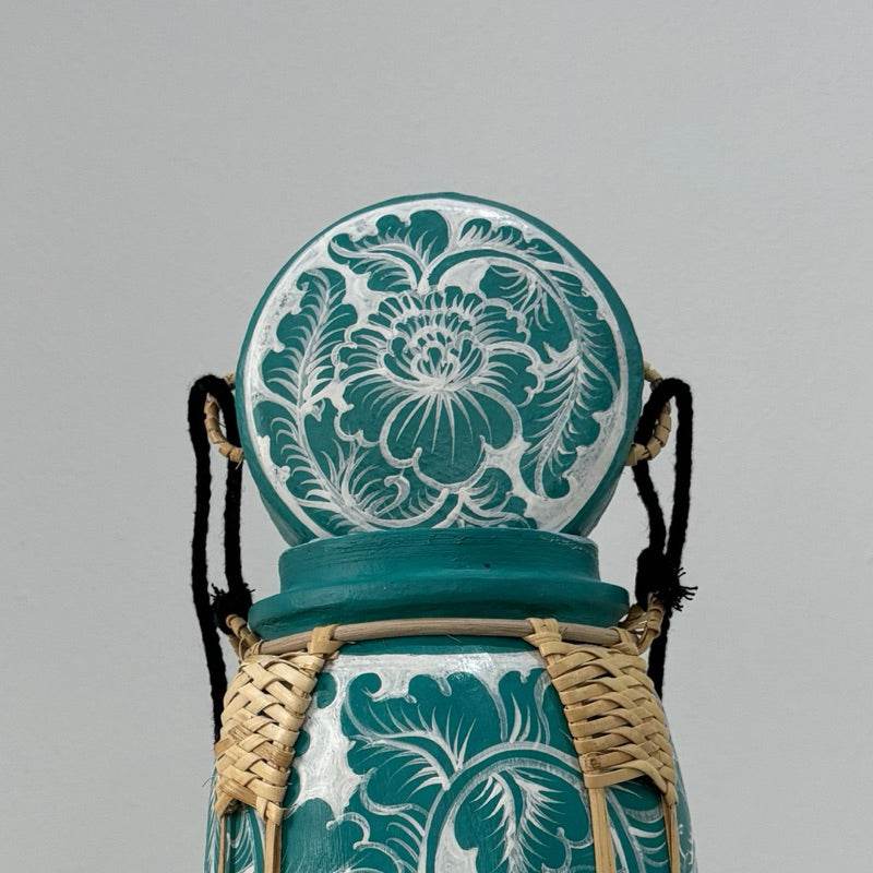 Handmade lanna bamboo rice box with intricate teal and white floral design and woven bamboo detailing