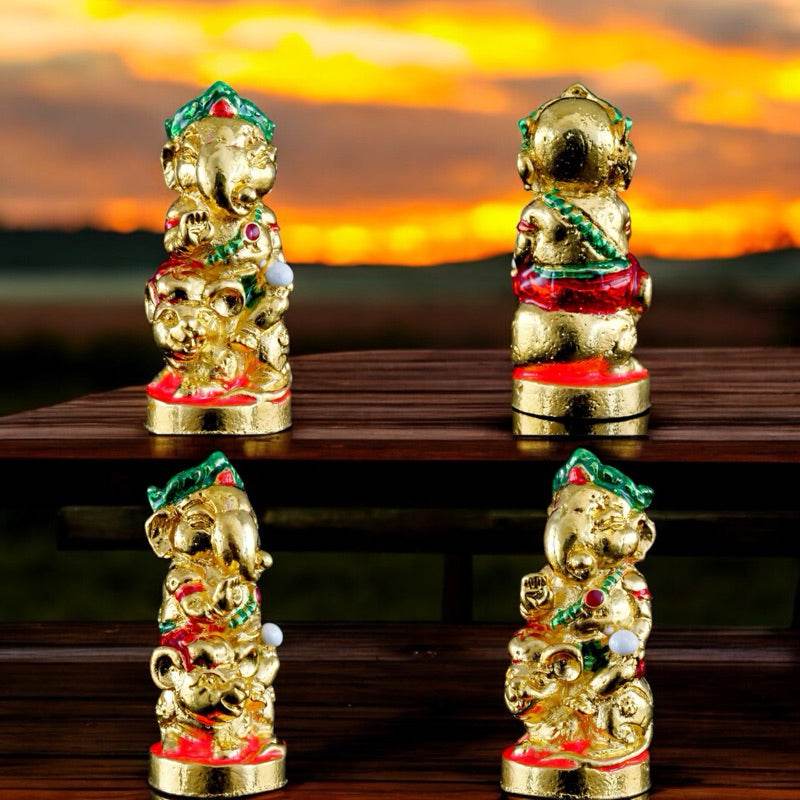 Ganesha blessing amulet Thailand gold figurine with colorful details shown from multiple angles on wooden surface
