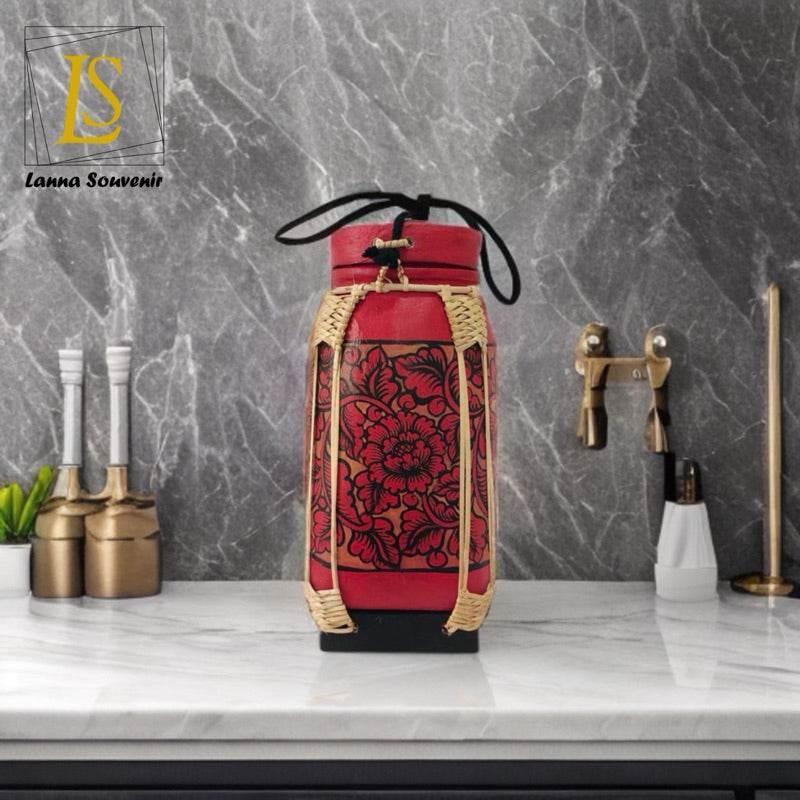 Handmade lanna bamboo rice box with red floral fabric and black carrying strap on kitchen countertop