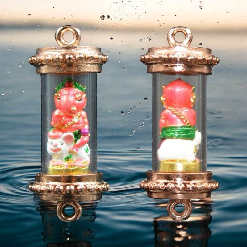 Thai Blessing Co Ganesha blessing amulet Thailand with intricate pink and green design in protective casing