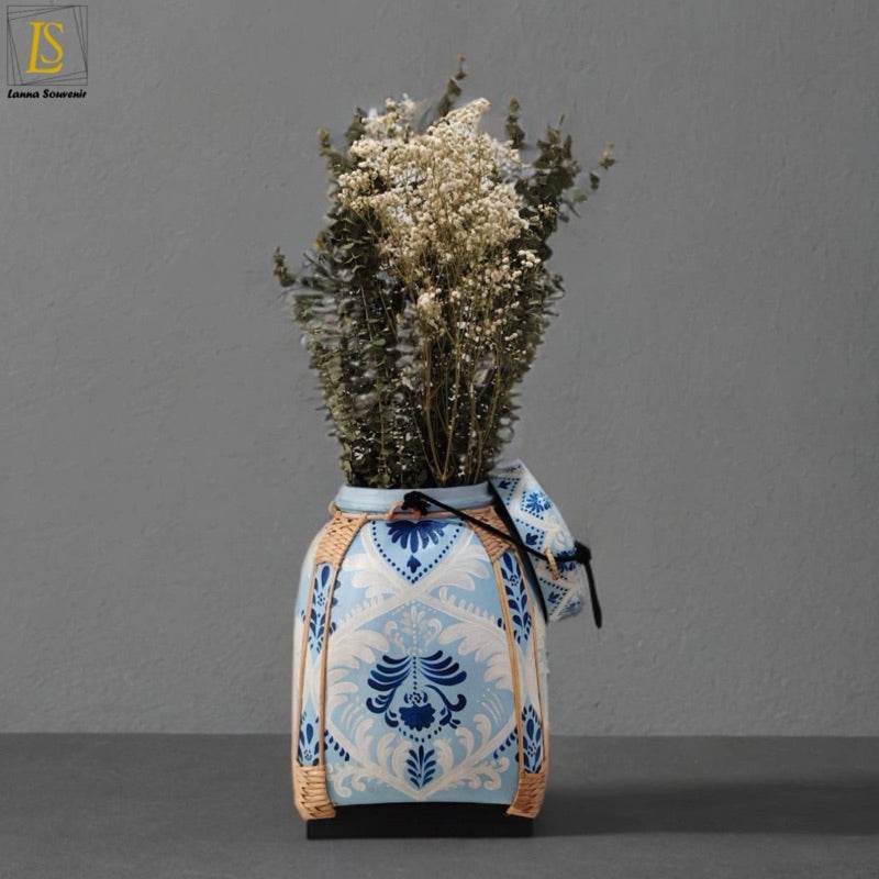 Handmade Thai decorative tray holding a blue and white ceramic vase with dried flowers