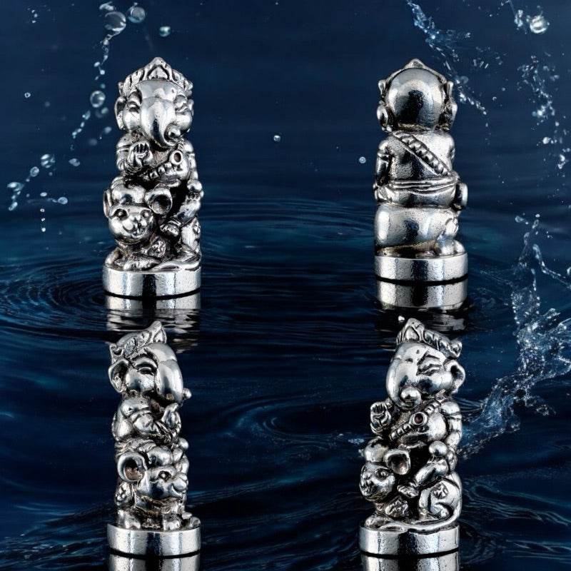Silver Ganesha blessing amulet Thailand shown from multiple angles on dark water background
