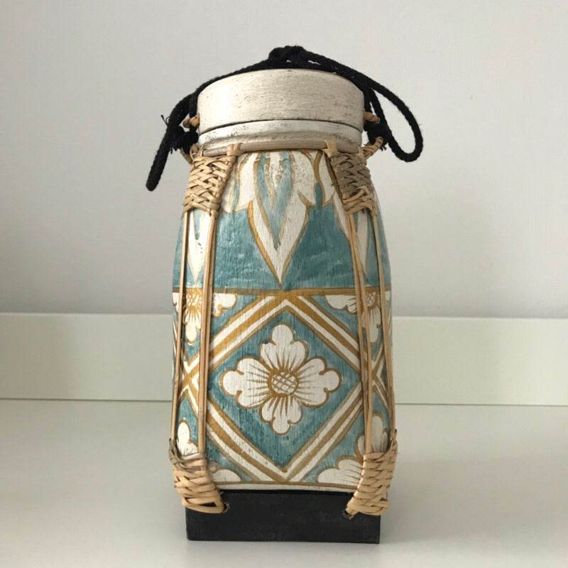 Handmade lanna bamboo rice box with intricate floral patterns and woven bamboo details