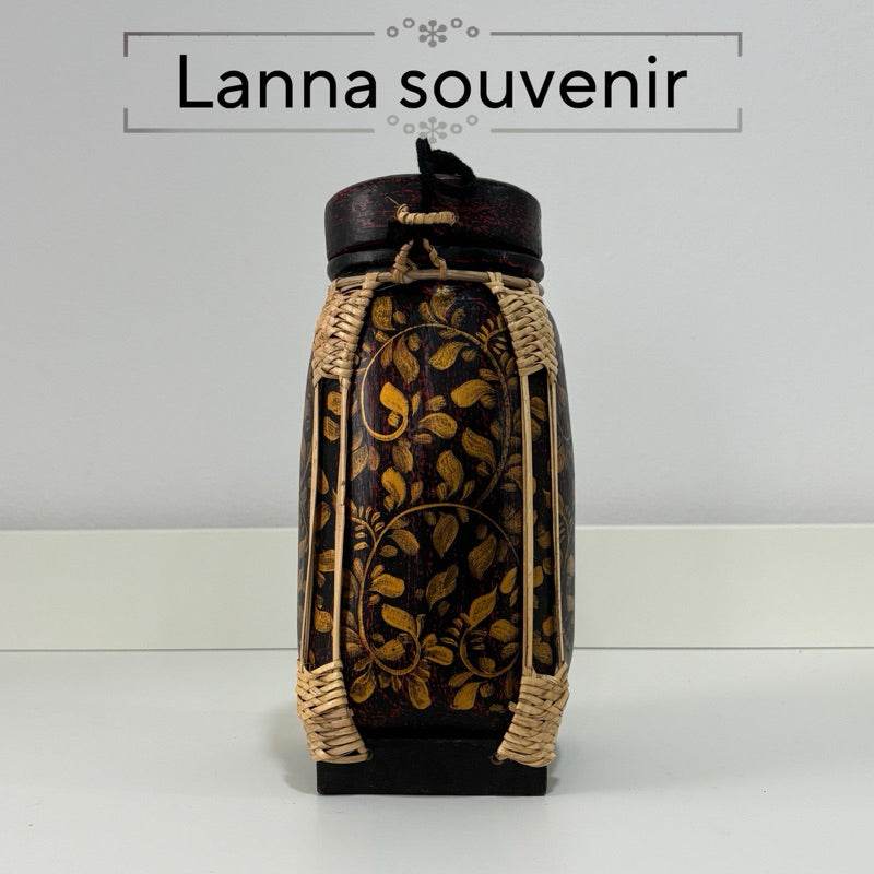 Handmade lanna bamboo rice box with intricate floral design and woven bamboo frame
