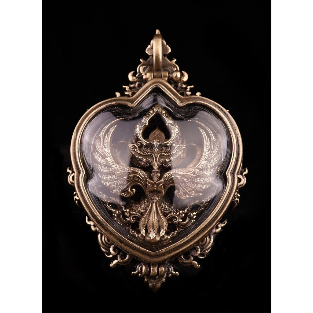 Decorative Garuda amulet for wealth and protection, intricately crafted with detailed design and a heart-shaped frame