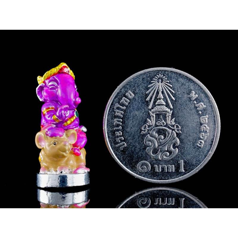 Small colorful Ganesha blessing amulet Thailand with Thai coin showing size comparison