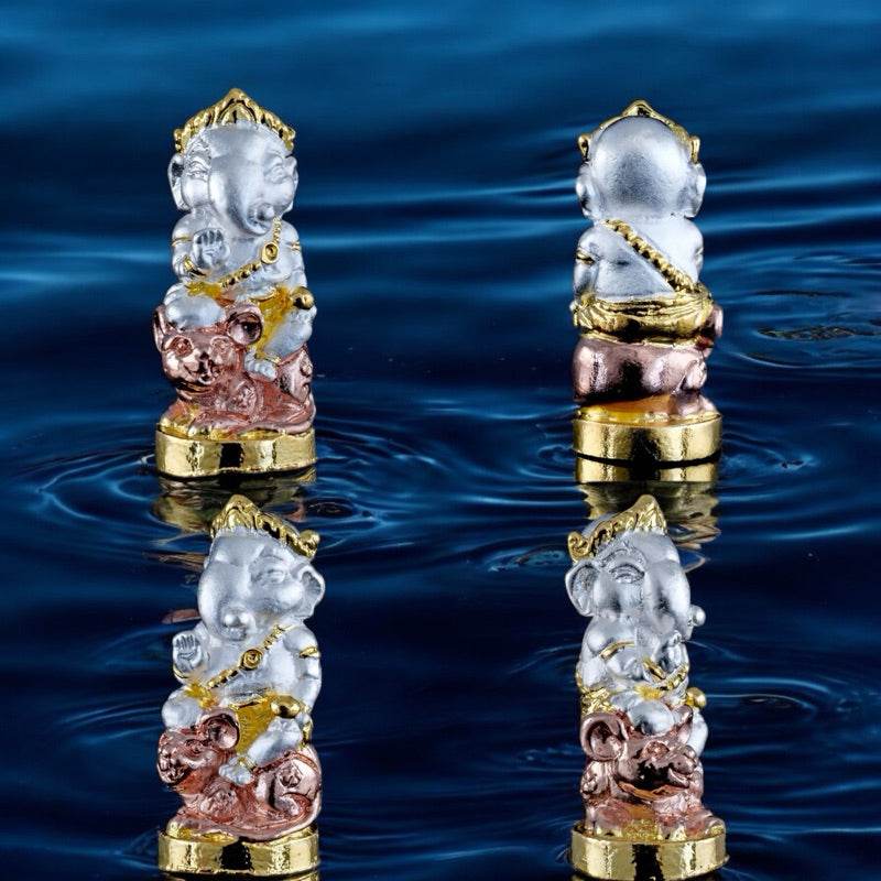 Ganesha blessing amulet Thailand small detailed statue in silver gold and bronze on water surface