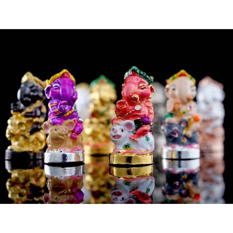 Colorful Ganesha blessing amulet Thailand figurines on reflective black surface by Thai Blessing Co