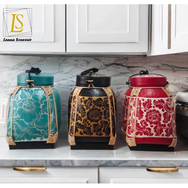 Set of three colorful handmade Thai decorative tray-style containers with intricate floral patterns on a kitchen countertop