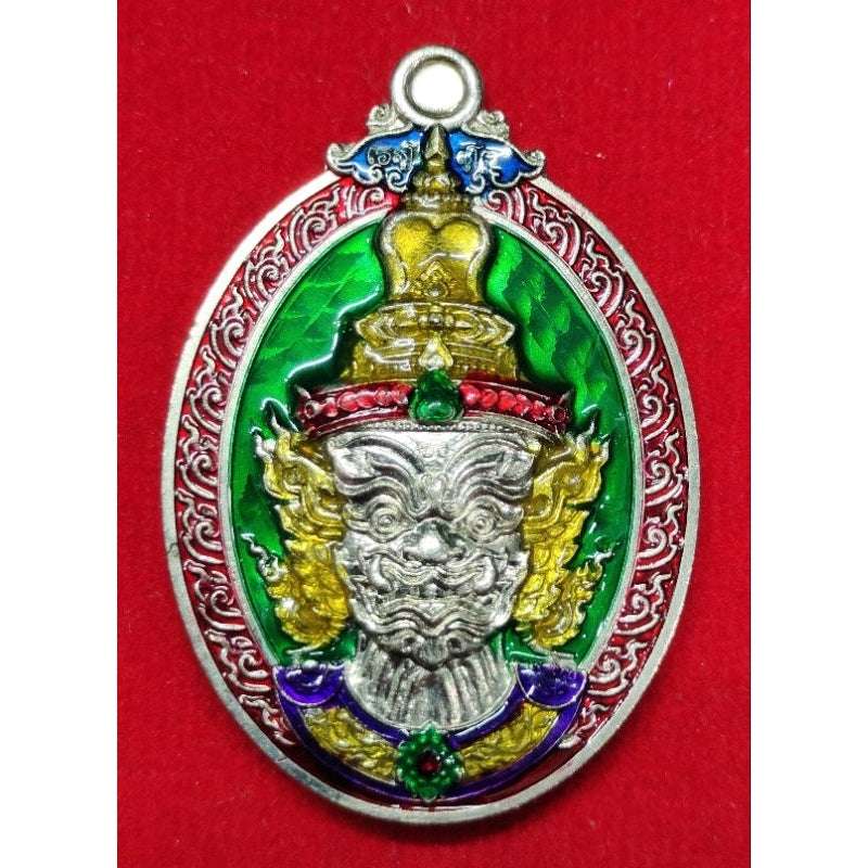 Thai Blessing Co Thaweesuwan wealth blessing amulet with intricate gold and green design on red background