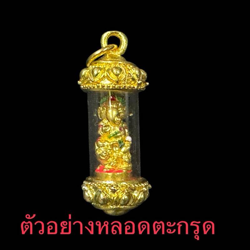 Ganesha blessing amulet Thailand with gold casing and detailed design inside transparent tube