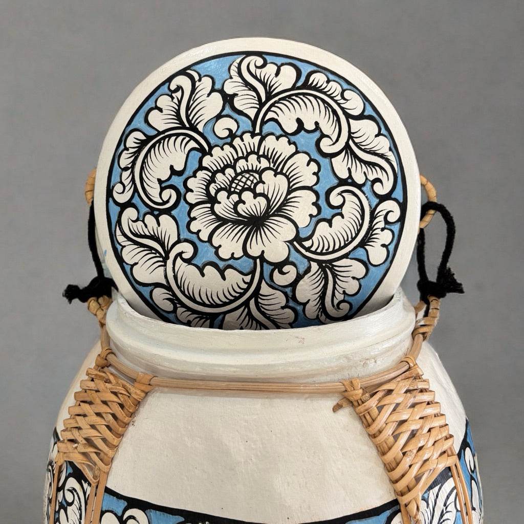 Handmade Thai decorative tray with intricate blue and white floral design displayed on a woven basket support