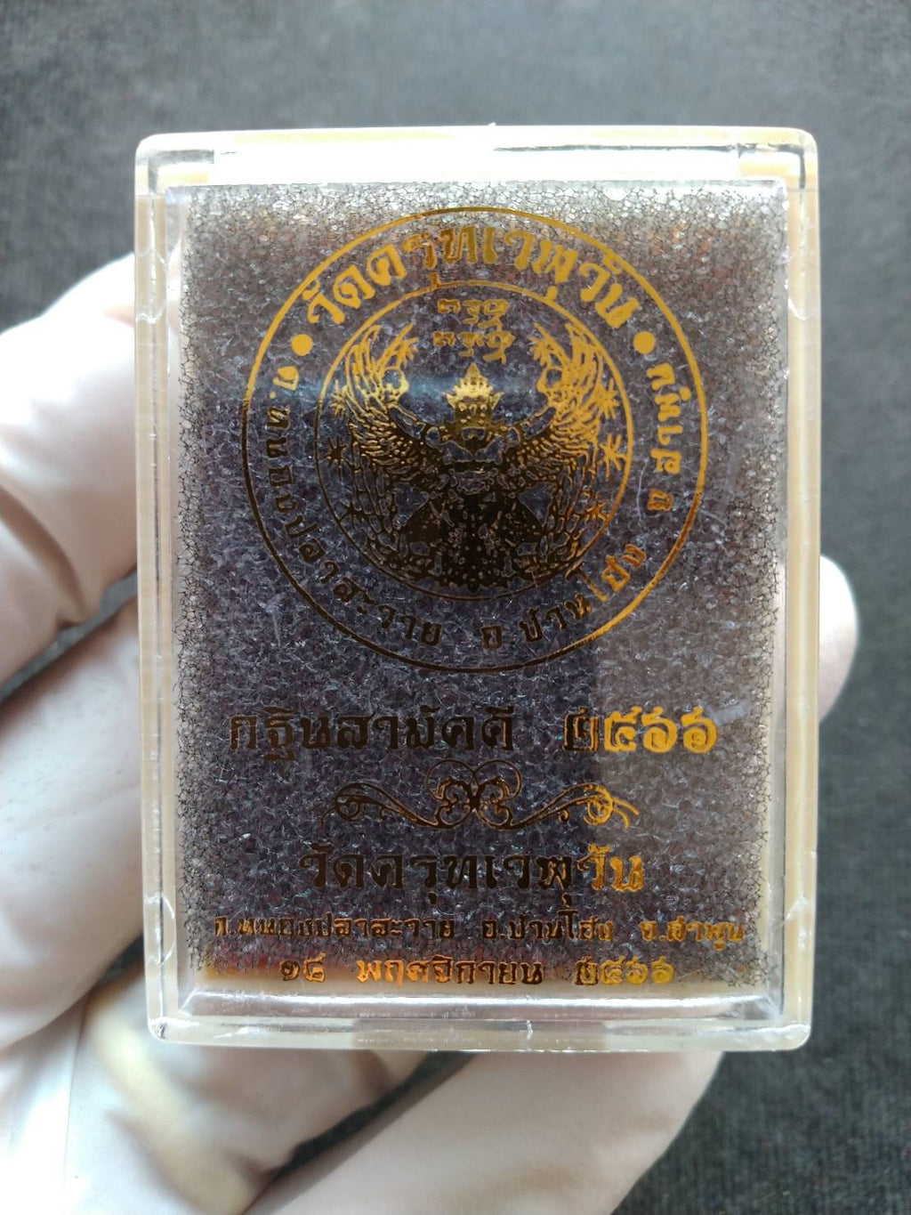 authentic Phaya Garuda lucky charm for sale in clear plastic case with gold Thai temple seal by Thai Blessing Co