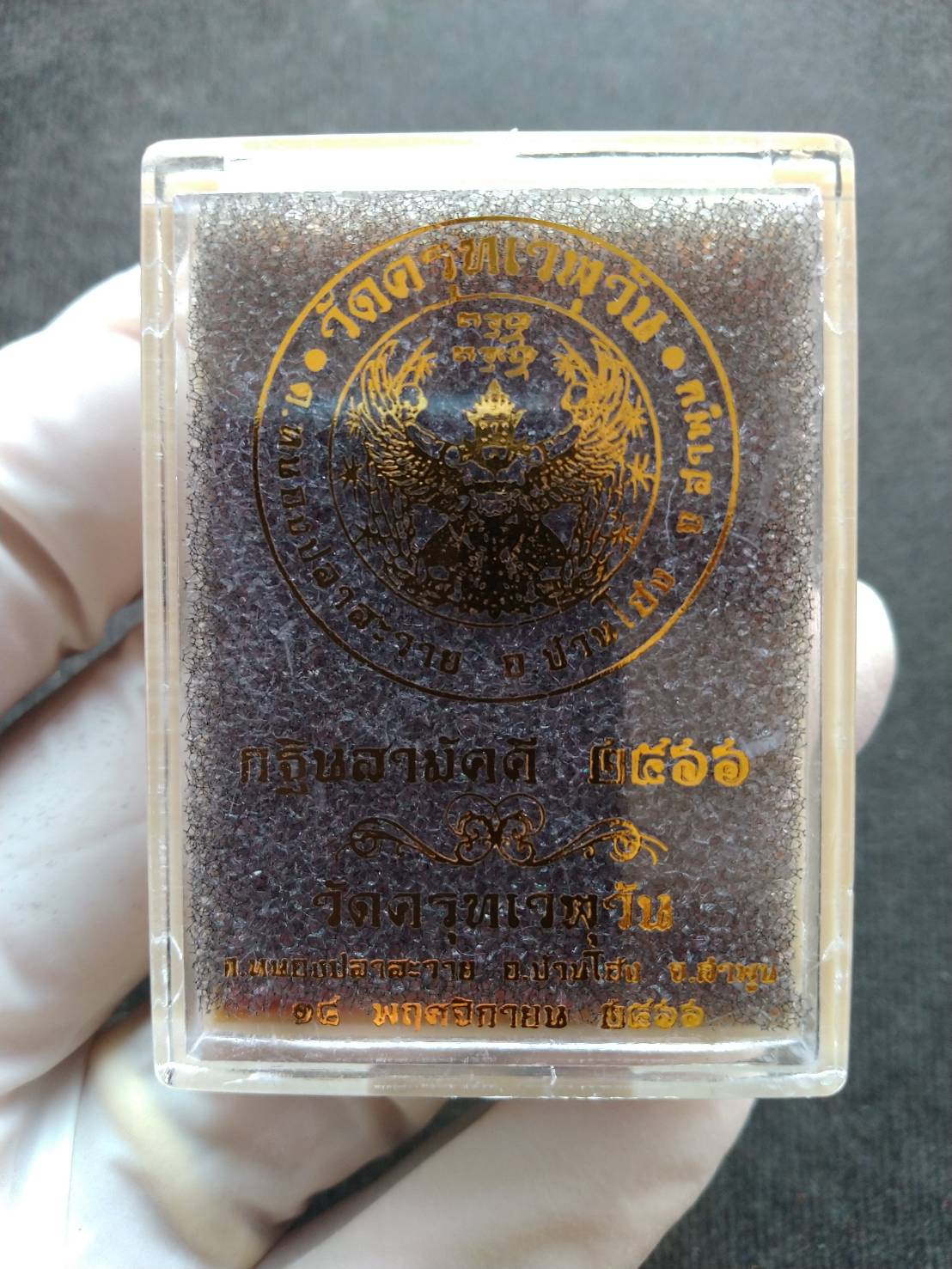 authentic Phaya Garuda lucky charm for sale in clear plastic case with gold Thai temple seal by Thai Blessing Co