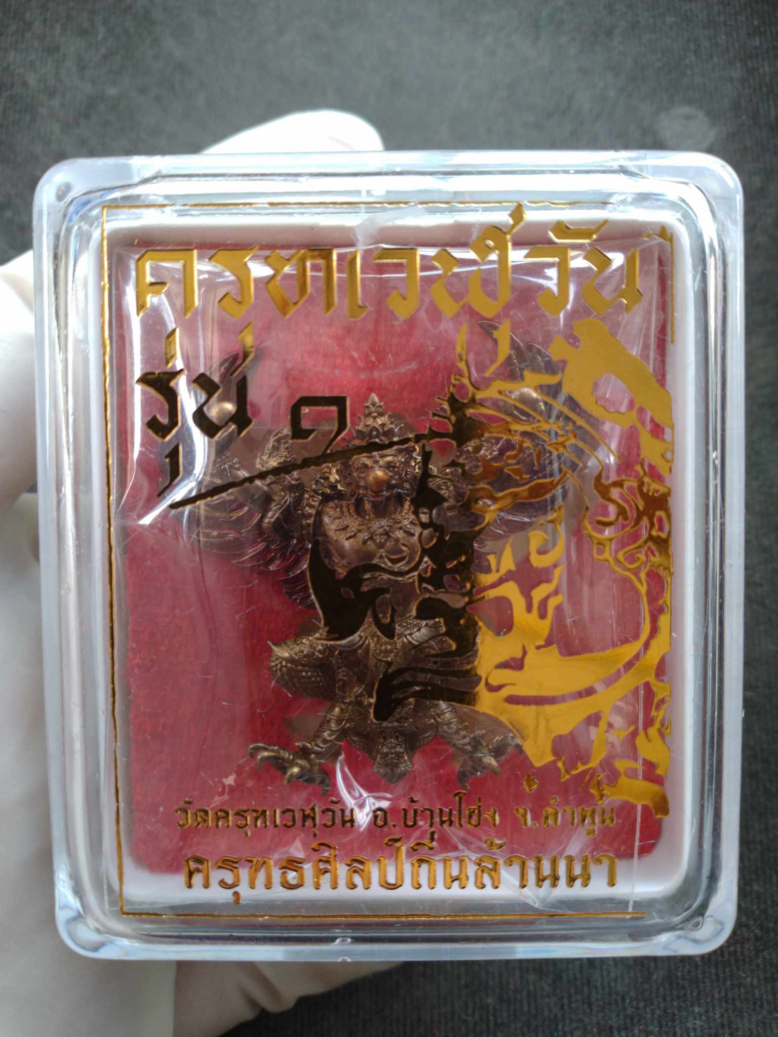 Thai Blessing Co first edition Garuda amulet for protection in clear case with red backing and gold Thai script