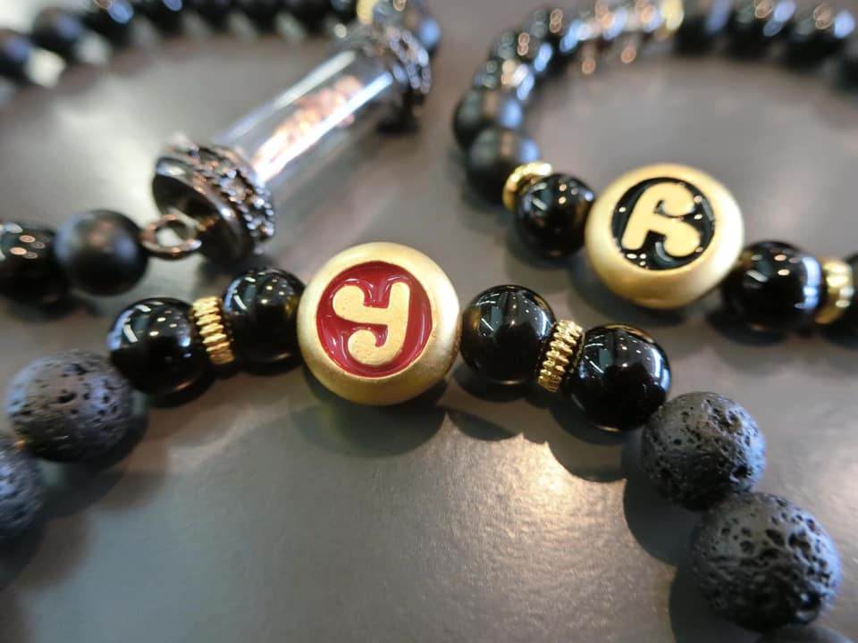 Thai amulet for protection and wealth crafted with black beads and ornate accents
