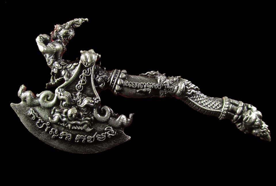 Ornate silver Great Axe Amulet Maha Prap with Thai script engravings and detailed decorative handle on black background