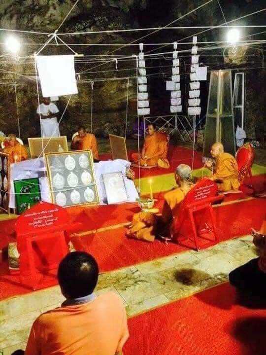 Great Ruesi amulet first edition displayed during a monk blessing ceremony in a Thai cave shrine