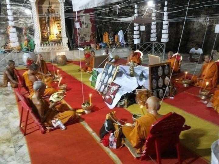 Monks performing blessing ceremony for Great Ruesi amulet first edition in temple setting