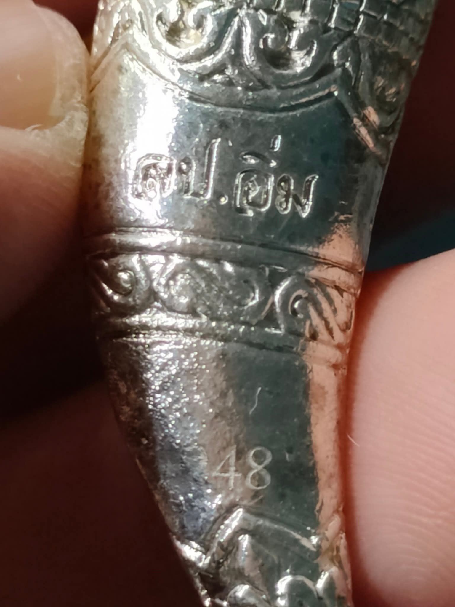 Thai Blessing Co Hanuman Sitting on Fangs silver amulet pendant with Thai script engraved 48 held between fingers