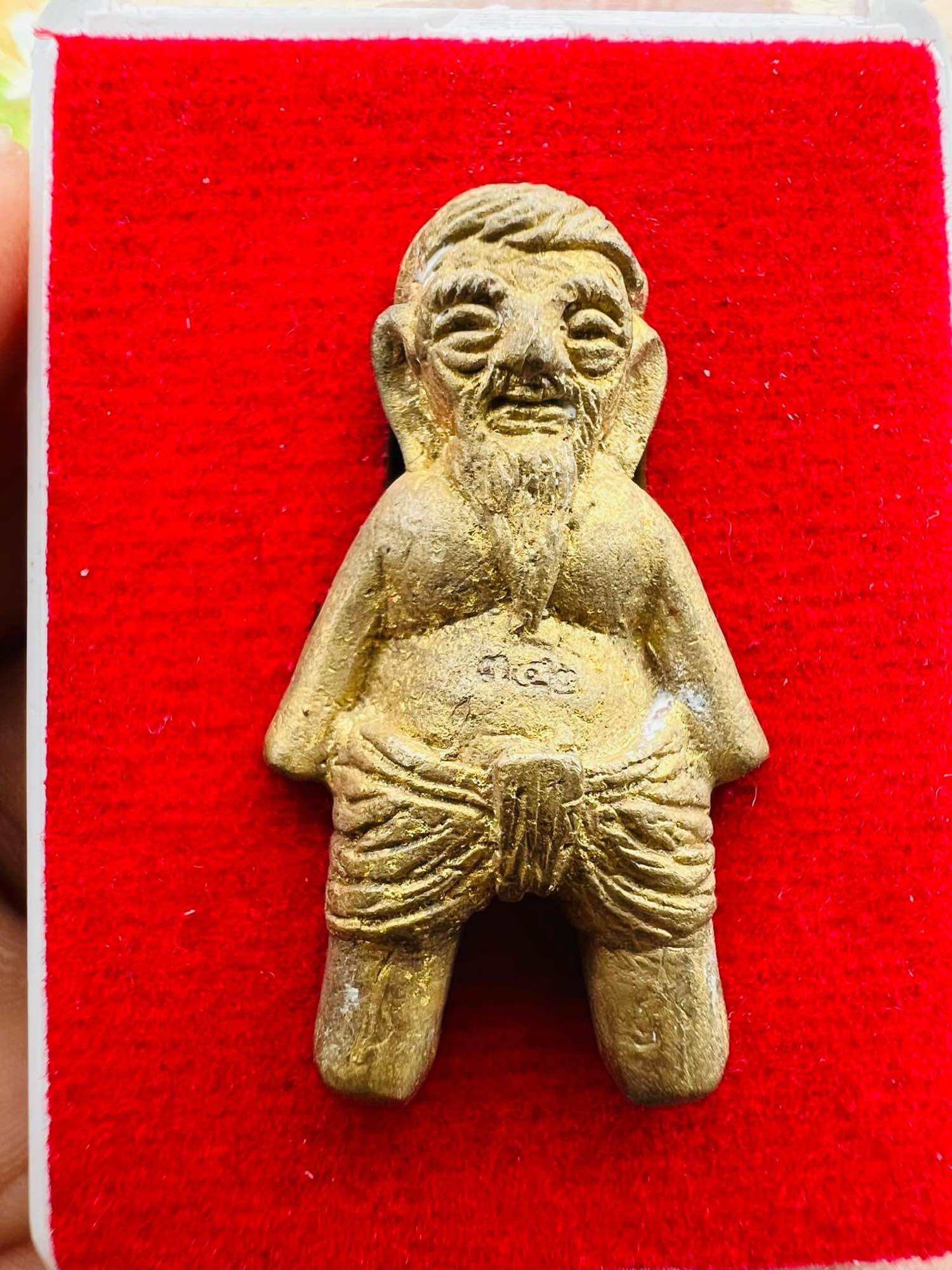 Hoon Payon ancient Thai guardian doll brass amulet of seated bearded elder on red velvet display