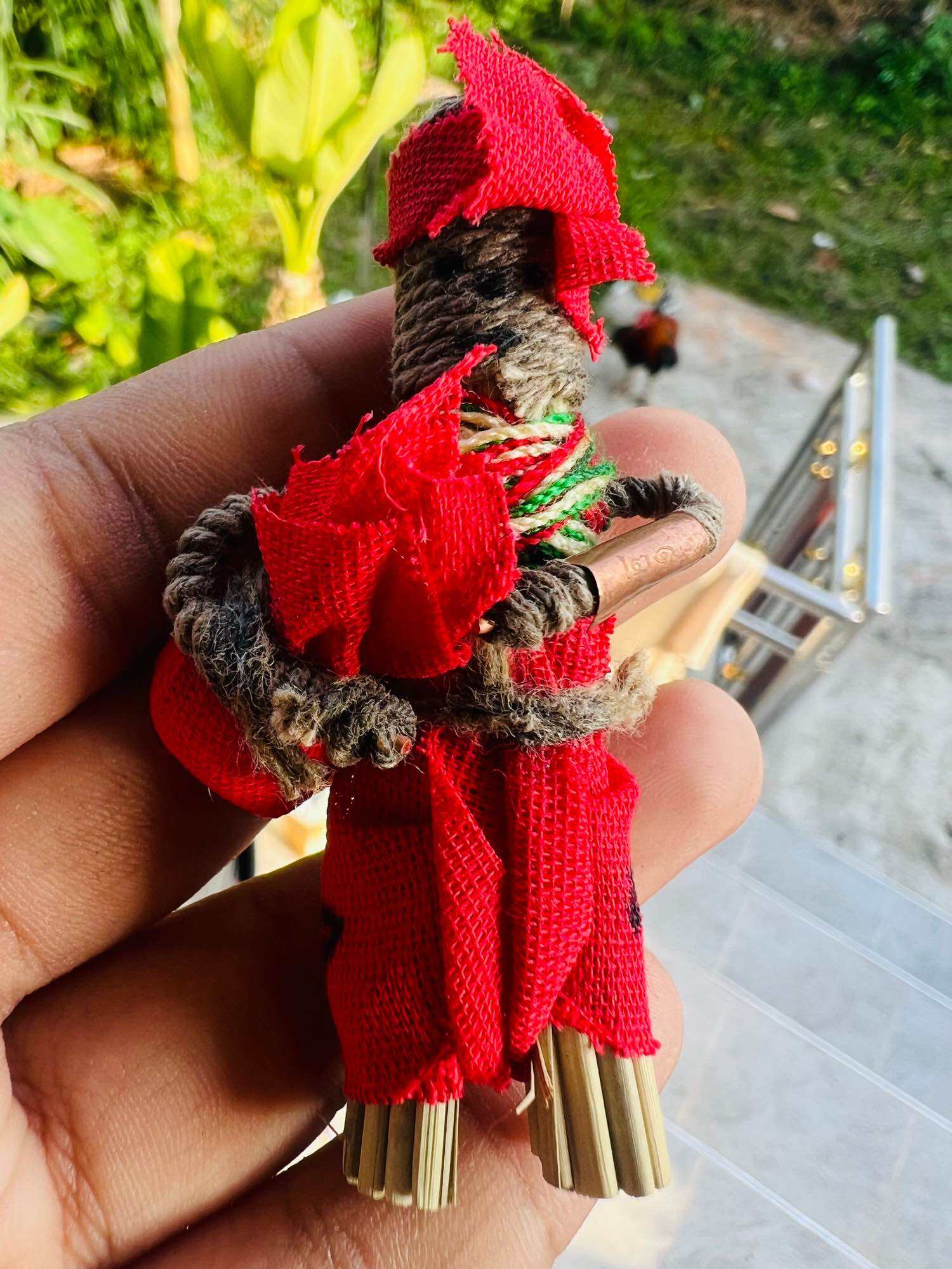 Handheld red cloth Hoon payon sacred puppet for protection talisman wrapped in braided cord with metal rods