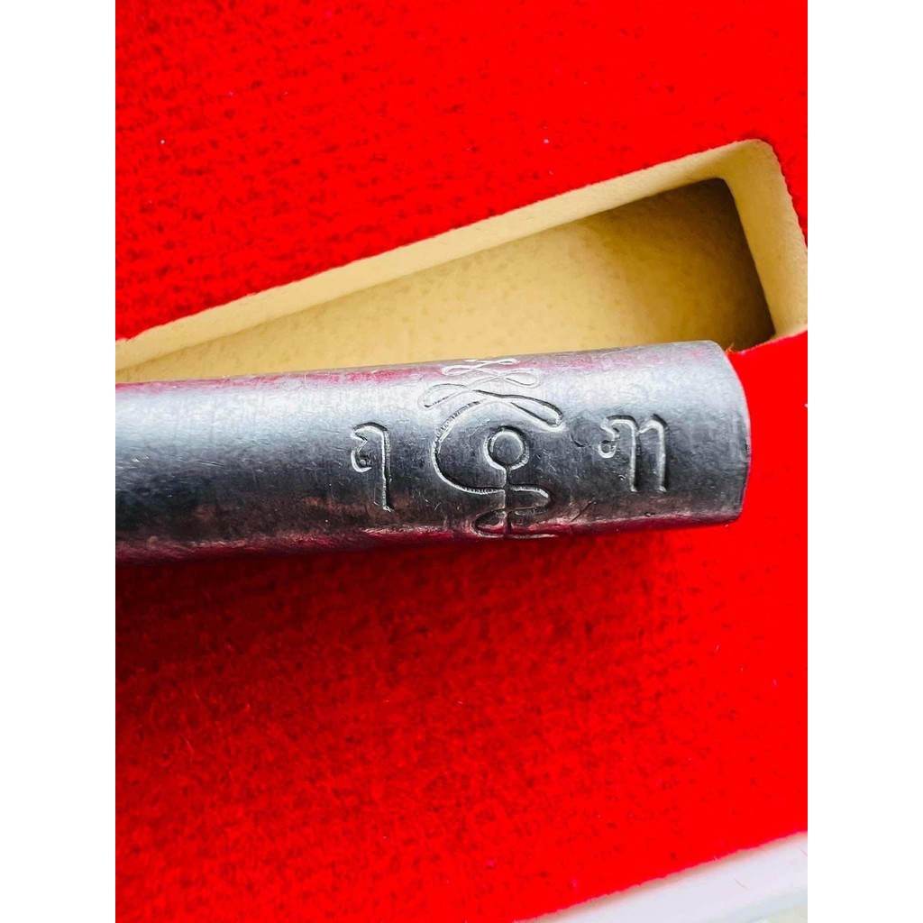 lead takrut blessed by Luang Pu Paew. Metal amulet cylinder engraved with Thai script in red presentation box