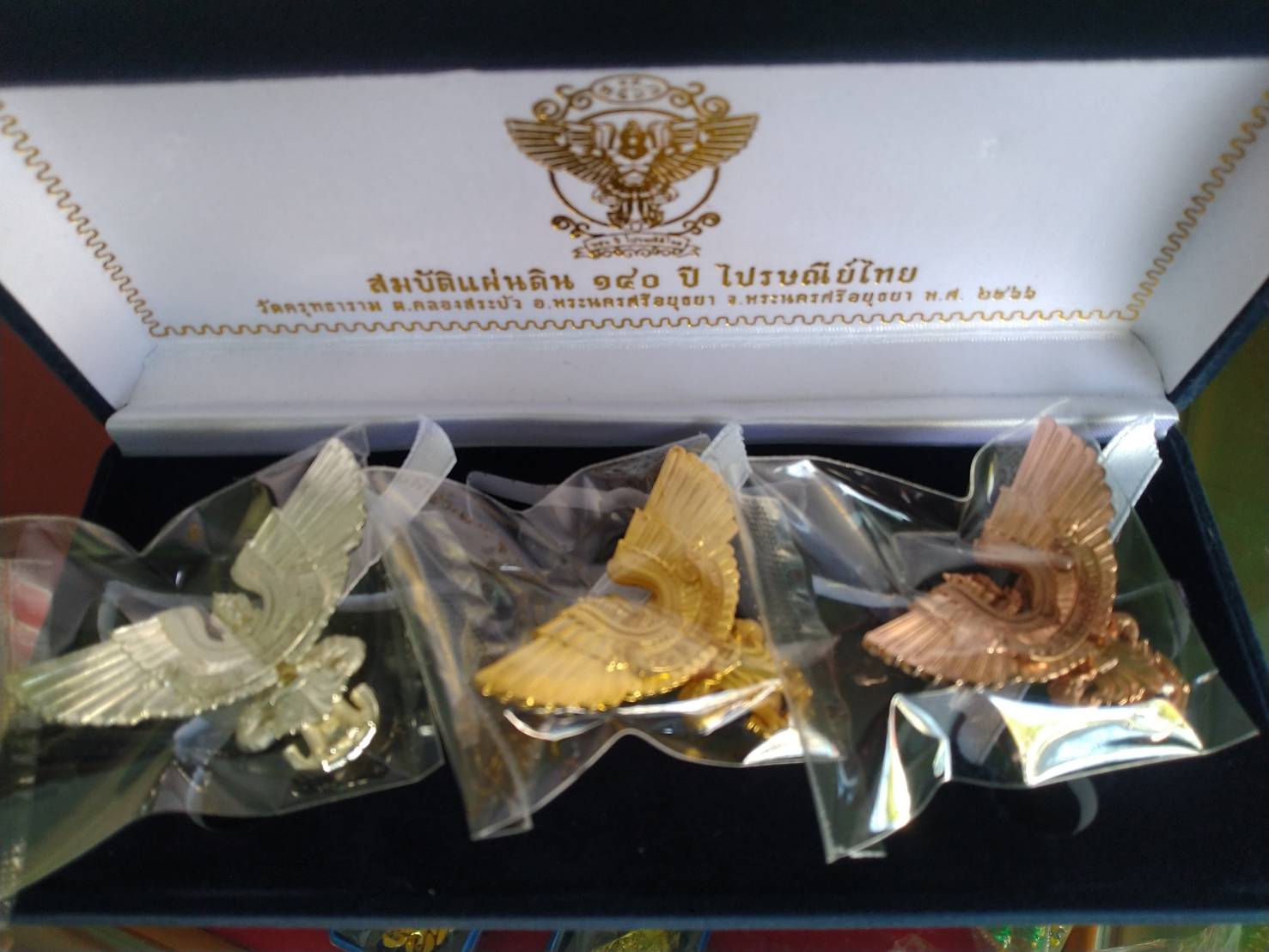 Thai Blessing Co presentation box with three metal Garuda pendants in silver gold and rose gold limited edition Garuda amulet set